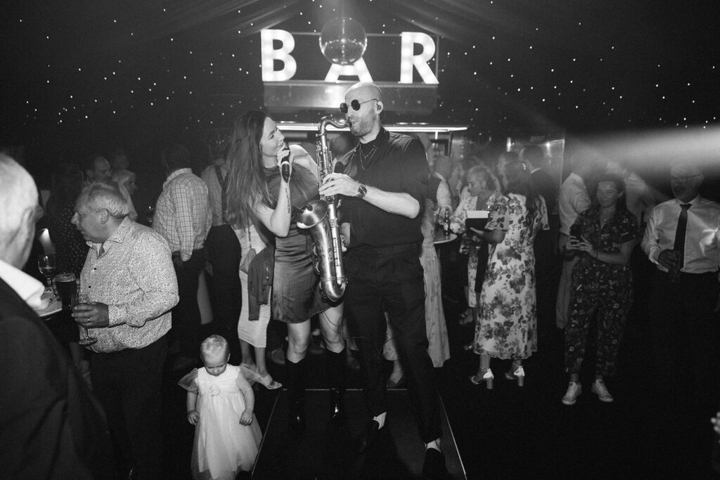 singer and sax player performing during a wedding party