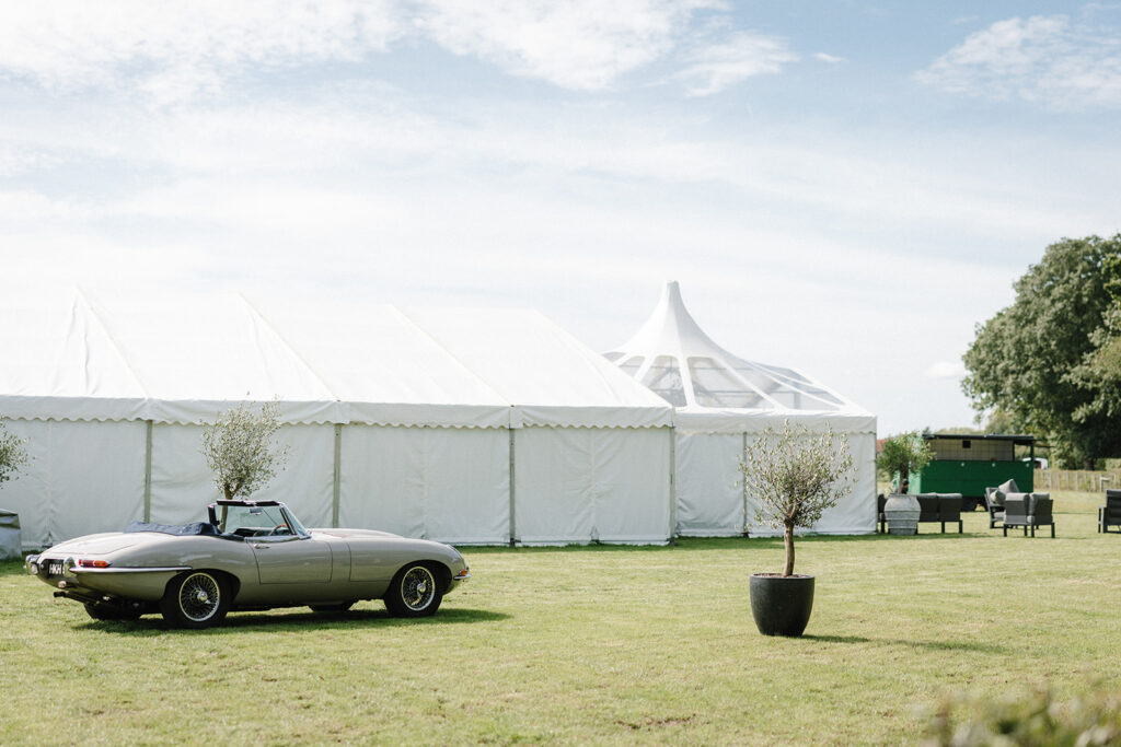 Jaguar E Type sitting outside a luxury marquee at a wedding in Kent.
