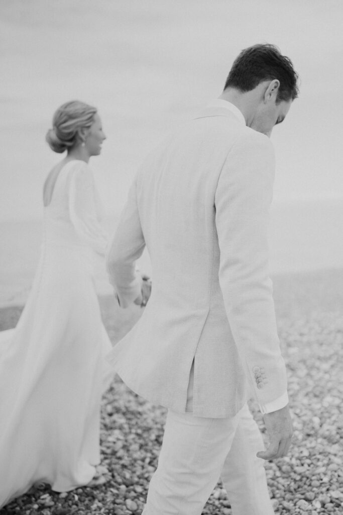 Oscar and Bella walking along the beach in Sandwich Bay on their way to their Sail and Peg Marquee at Oscars family home