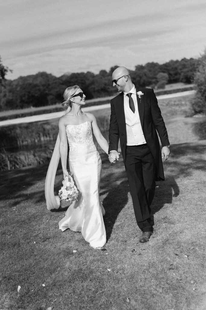 Martin and Janie walking towards their marquee wedding reception in Ashford, Kent
