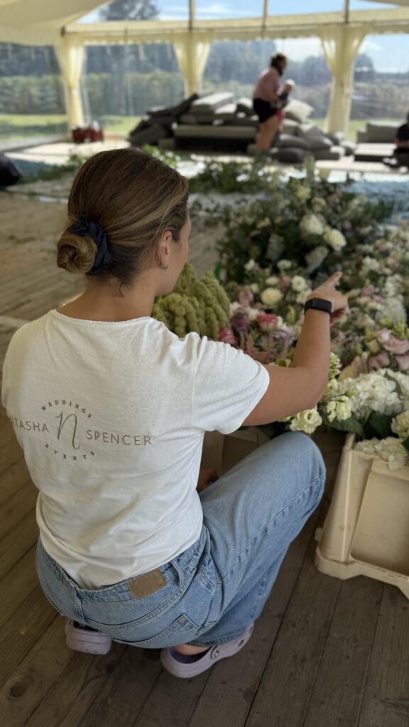 Wedding planner counting table florals as a marquee design comes together
