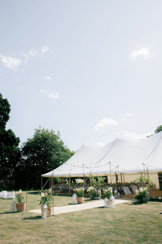 Holmstead Events sailcloth marquee at private home with walkway and hydrangea pots for decoration