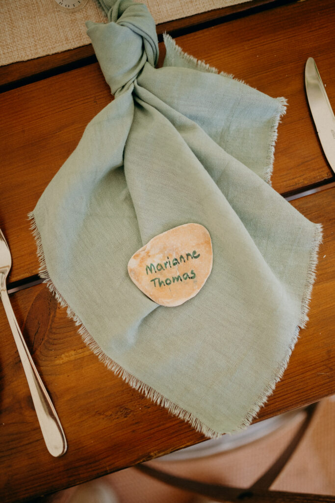hand drawn place name in an oyster shell made by a bride for a luxury marquee wedding