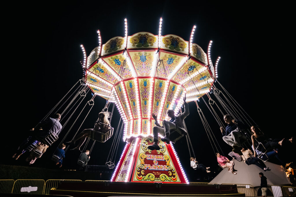 Chair o Planes lit up in the dark at a carnival after party of a luxury wedding in Kent